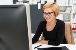 Frau sitzt vor einem Bildschirm. Foto: contrastwerkstatt/Fotolia.com