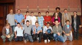 Ein Gruppenbild mit Jugendlichen und Erwachsenen, in der vorderen Reihe hocken die Teilnehmenden auf dem Boden. Einige Personen halten Trommeln in der Hand. Foto: Stadt Oldenburg