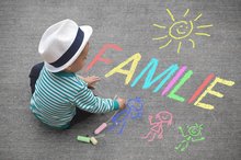 Child with chalk drawing the word familiy. Picture: motorradcbr/Fotolia.com